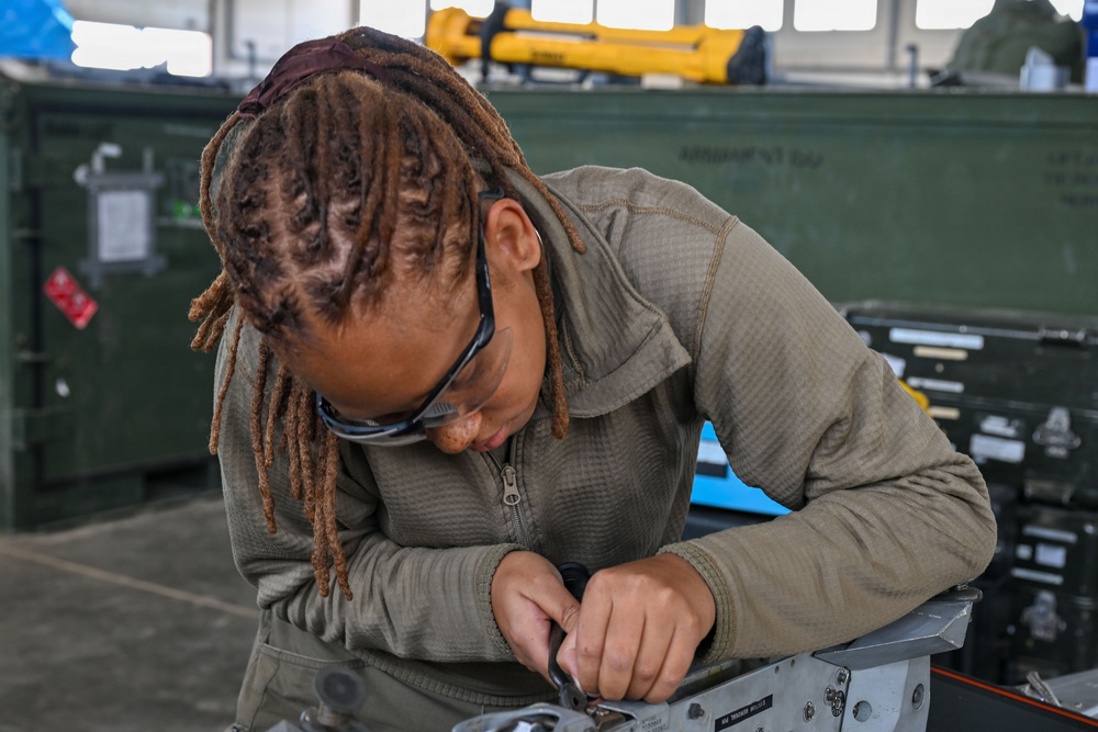 Airman assembles aircraft weapon components