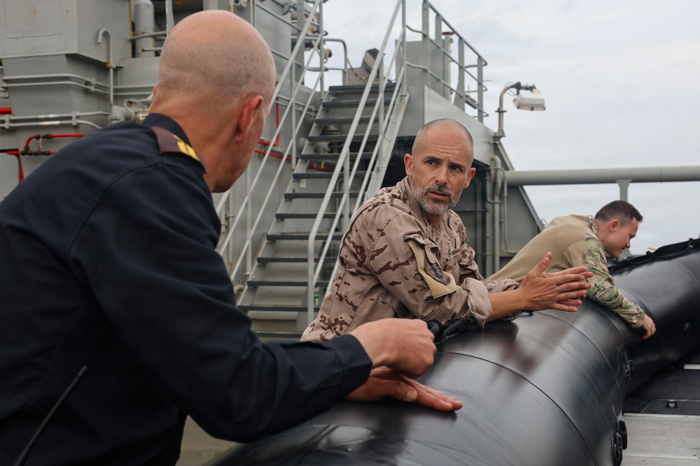 RWC Justin Weatherford discuss loading an unmanned underwater vehicle (UUV) with the Spanish Armada