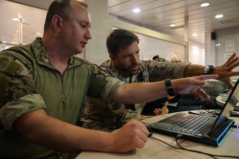 MN1 Merrick Ziegenbein 3 conducts a post mission analysis with Spanish Mariner First Sergeant Fran Morcillo during ESP MINEX-26