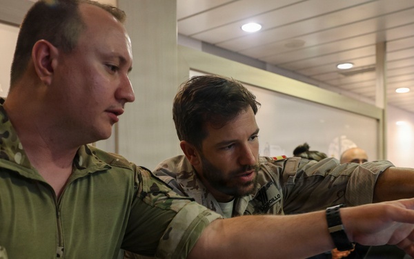 MN1 Merrick Ziegenbein 3 conducts a post mission analysis with Spanish Mariner First Sergeant Fran Morcillo during ESP MINEX-26