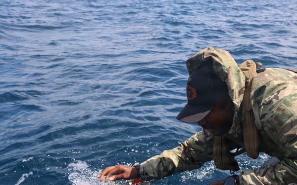 OS1 Drew Upchurch launches an MK 18 Mod 1 Unmanned Underwater Vehicle during ESP MINEX-26