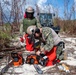 NMCB 1 Sailors clear an area with chainsaws and a backhoe