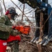 NMCB 1 Sailors clear an area with chainsaws and a backhoe
