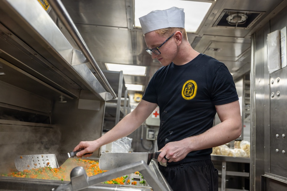 Sailors prepare food aboard USS Donald Cook
