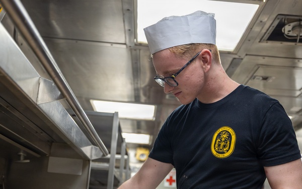 Sailors prepare food aboard USS Donald Cook