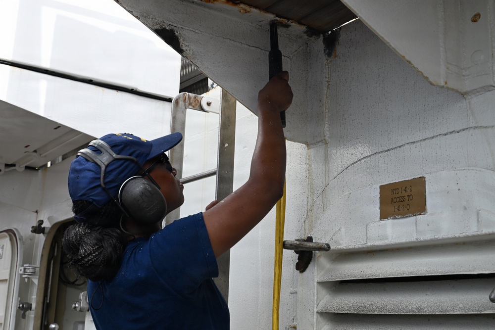 USCGC Eagle crew members and cadets prep the training barque for paint ahead of America 250 events