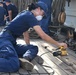 USCGC Eagle crew members and cadets prep the training barque for paint ahead of America 250 events
