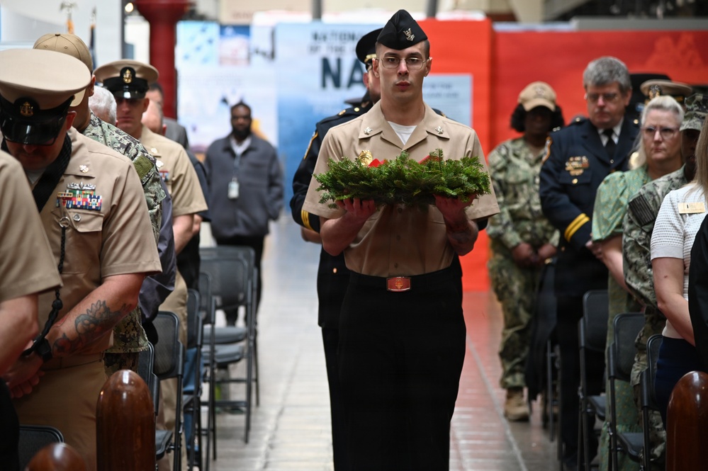 Master at Arms Carries Wreath During NSAW Security Force Memorial