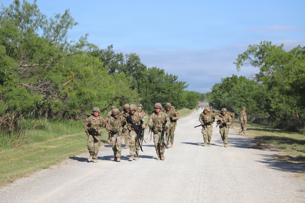 Best Redleg Competitors from 1st Armored Division Artillery complete the 12 mile ruck to conclude the 2026 Best Redleg Competition