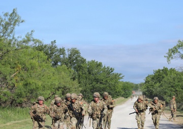 Best Redleg Competitors from 1st Armored Division Artillery complete the 12 mile ruck to conclude the 2026 Best Redleg Competition