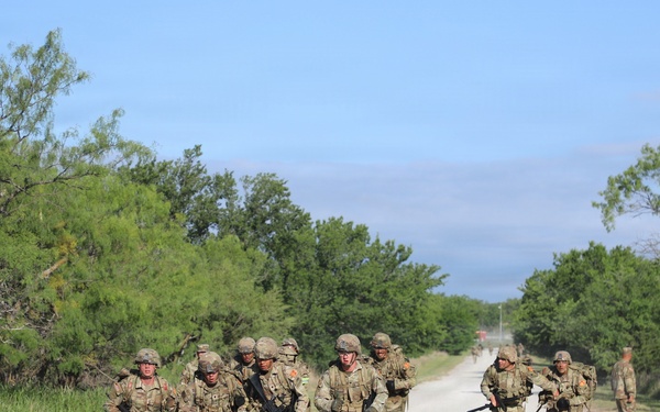 Best Redleg Competitors from 1st Armored Division Artillery complete the 12 mile ruck to conclude the 2026 Best Redleg Competition