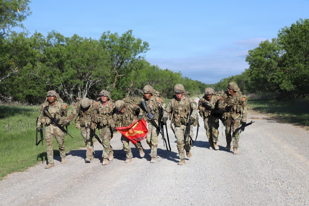 Best Redleg Competitors from 1st Armored Division Artillery complete the 12 mile ruck to conclude the 2026 Best Redleg Competition