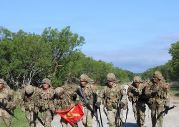 Best Redleg Competitors from 1st Armored Division Artillery complete the 12 mile ruck to conclude the 2026 Best Redleg Competition