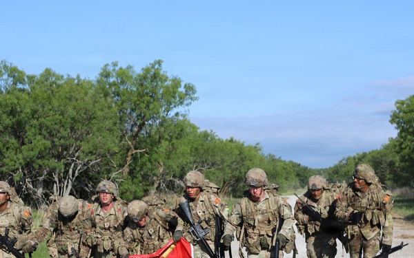Best Redleg Competitors from 1st Armored Division Artillery complete the 12 mile ruck to conclude the 2026 Best Redleg Competition
