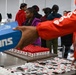 U.S. Army Tank-automotive and Armaments Command and Detroit Arsenal Soldiers join Detroit Lions Academy students to pack care kits for deployed Soldiers