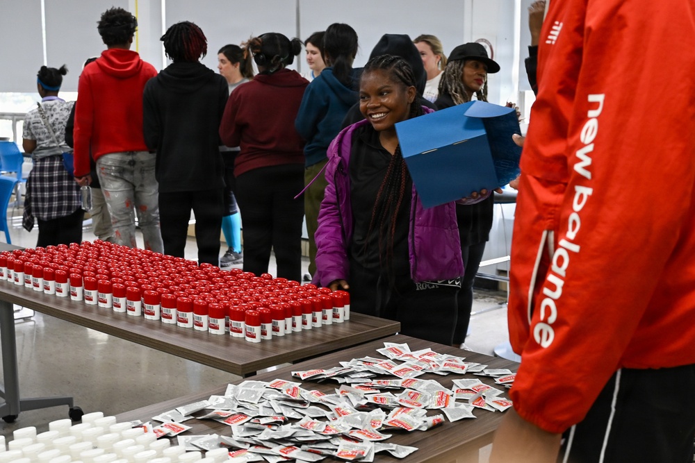 U.S. Army Tank-automotive and Armaments Command and Detroit Arsenal Soldiers join Detroit Lions Academy students to pack care kits for deployed Soldiers