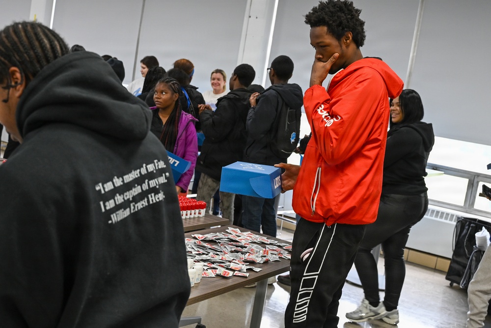 U.S. Army Tank-automotive and Armaments Command and Detroit Arsenal Soldiers join Detroit Lions Academy students to pack care kits for deployed Soldiers