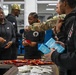 U.S. Army Tank-automotive and Armaments Command and Detroit Arsenal Soldiers join Detroit Lions Academy students to pack care kits for deployed Soldiers