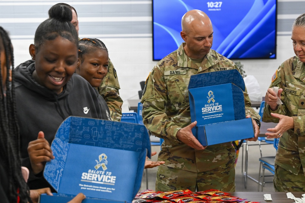U.S. Army Tank-automotive and Armaments Command and Detroit Arsenal Soldiers join Detroit Lions Academy students to pack care kits for deployed Soldiers