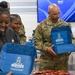 U.S. Army Tank-automotive and Armaments Command and Detroit Arsenal Soldiers join Detroit Lions Academy students to pack care kits for deployed Soldiers