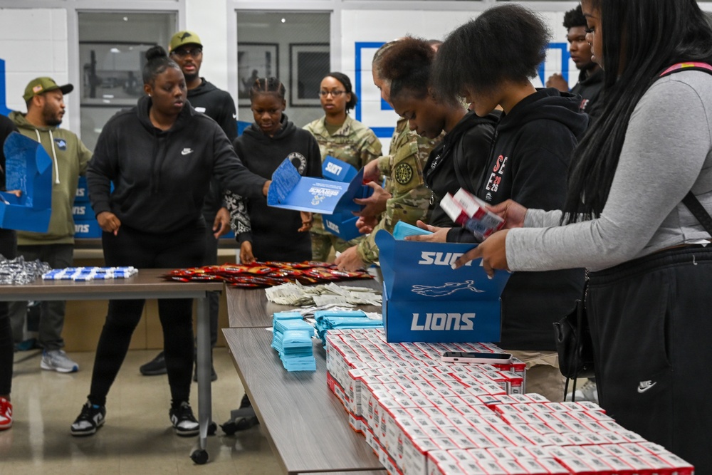 U.S. Army Tank-automotive and Armaments Command and Detroit Arsenal Soldiers join Detroit Lions Academy students to pack care kits for deployed Soldiers
