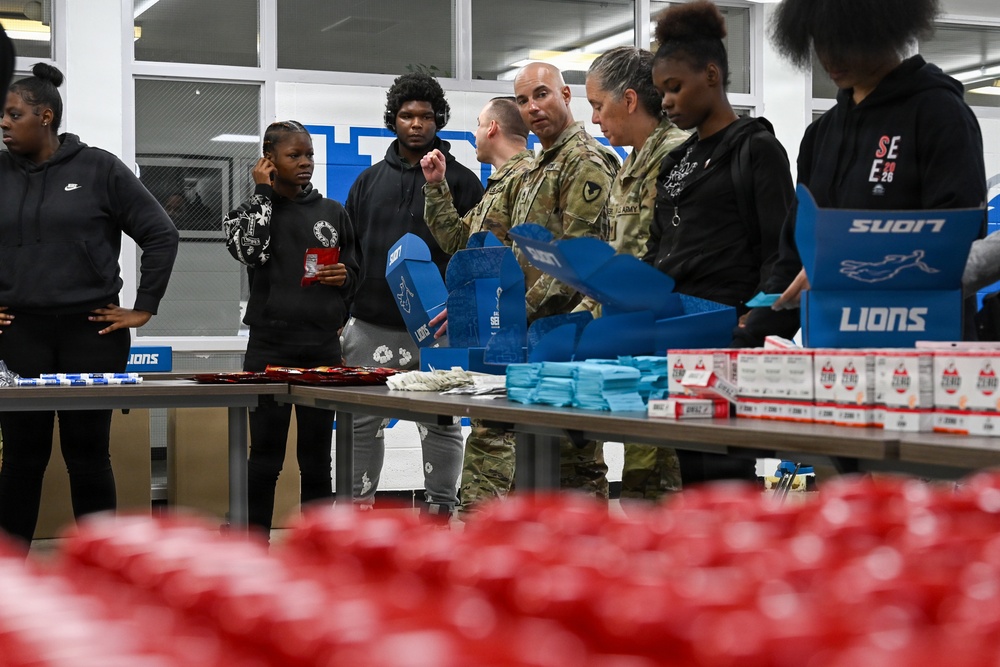 U.S. Army Tank-automotive and Armaments Command and Detroit Arsenal Soldiers join Detroit Lions Academy students to pack care kits for deployed Soldiers
