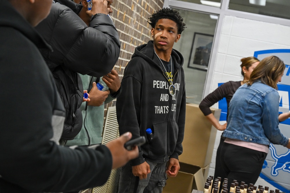U.S. Army Tank-automotive and Armaments Command and Detroit Arsenal Soldiers join Detroit Lions Academy students to pack care kits for deployed Soldiers