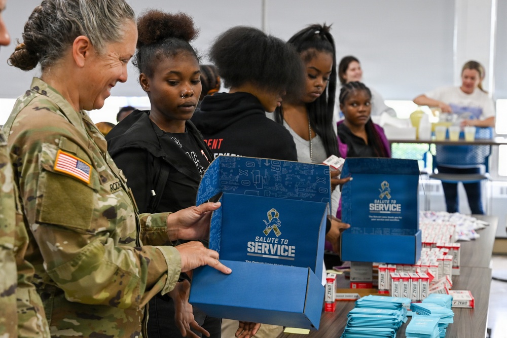 U.S. Army Tank-automotive and Armaments Command and Detroit Arsenal Soldiers join Detroit Lions Academy students to pack care kits for deployed Soldiers