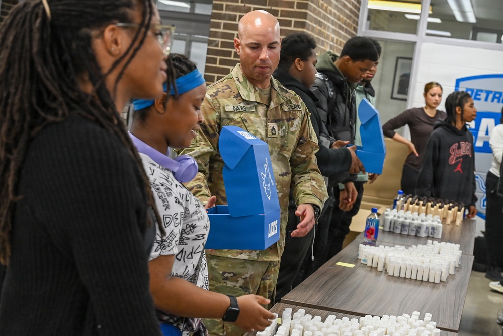 U.S. Army Tank-automotive and Armaments Command and Detroit Arsenal Soldiers join Detroit Lions Academy students to pack care kits for deployed Soldiers