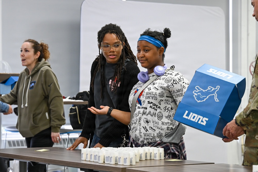 U.S. Army Tank-automotive and Armaments Command and Detroit Arsenal Soldiers join Detroit Lions Academy students to pack care kits for deployed Soldiers