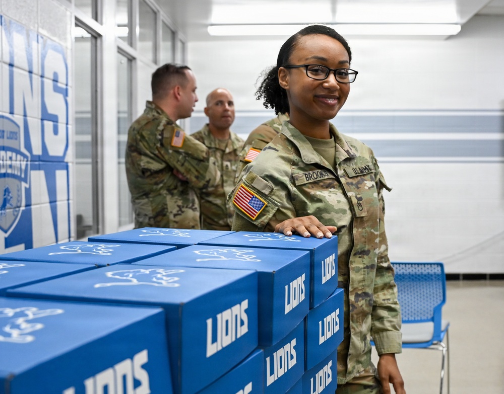 U.S. Army Tank-automotive and Armaments Command and Detroit Arsenal Soldiers join Detroit Lions Academy students to pack care kits for deployed Soldiers