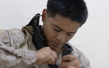U.S. Marines clean and inspect M4 carbines