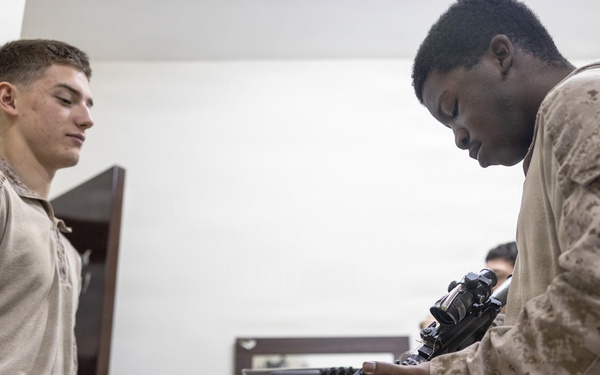 U.S. Marines clean and inspect M4 carbines