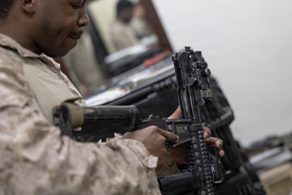U.S. Marines clean and inspect M4 carbines