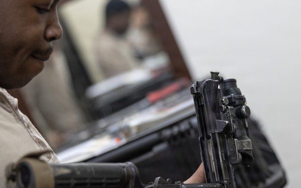 U.S. Marines clean and inspect M4 carbines