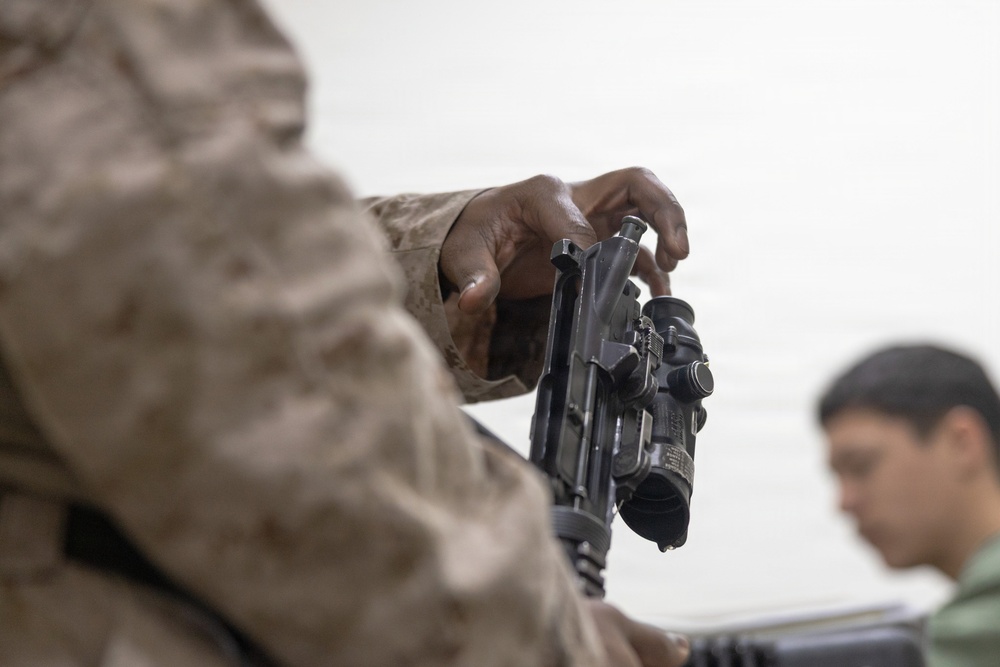U.S. Marines clean and inspect M4 carbines
