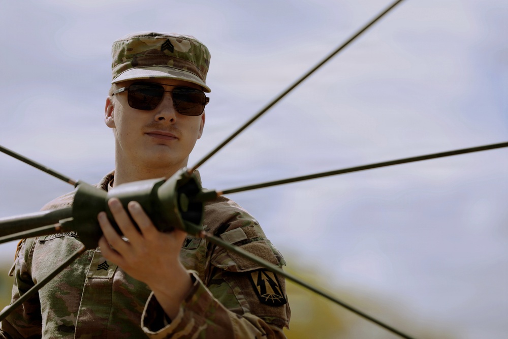 U.S. Army Soldier with the 335th Signal Command Sets Up Antennas in Preparation for the Best Squad Competition