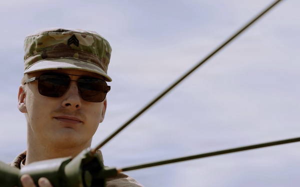 U.S. Army Soldier with the 335th Signal Command Sets Up Antennas in Preparation for the Best Squad Competition