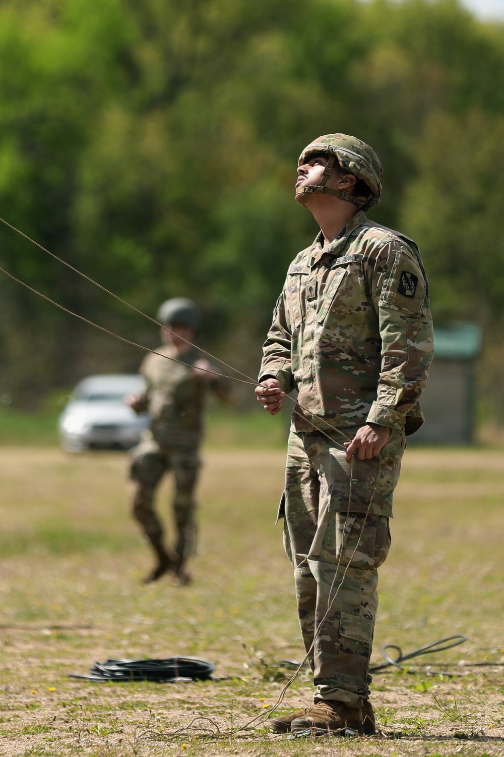 U.S. Army Soldier with the 335th Signal Command Sets Up Antennas for the Best Squad Competition