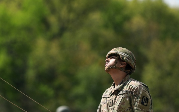U.S. Army Soldier with the 335th Signal Command Sets Up Antennas for the Best Squad Competition