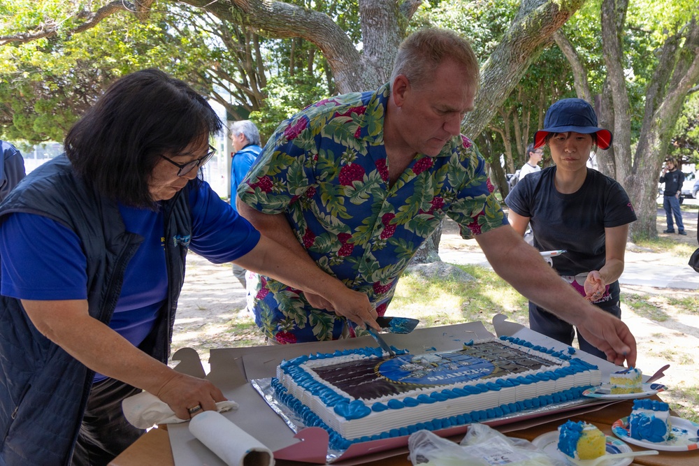 Deputy Public Works Officer David Frankranzen serves cake during a picnic