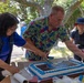 Deputy Public Works Officer David Frankranzen serves cake during a picnic