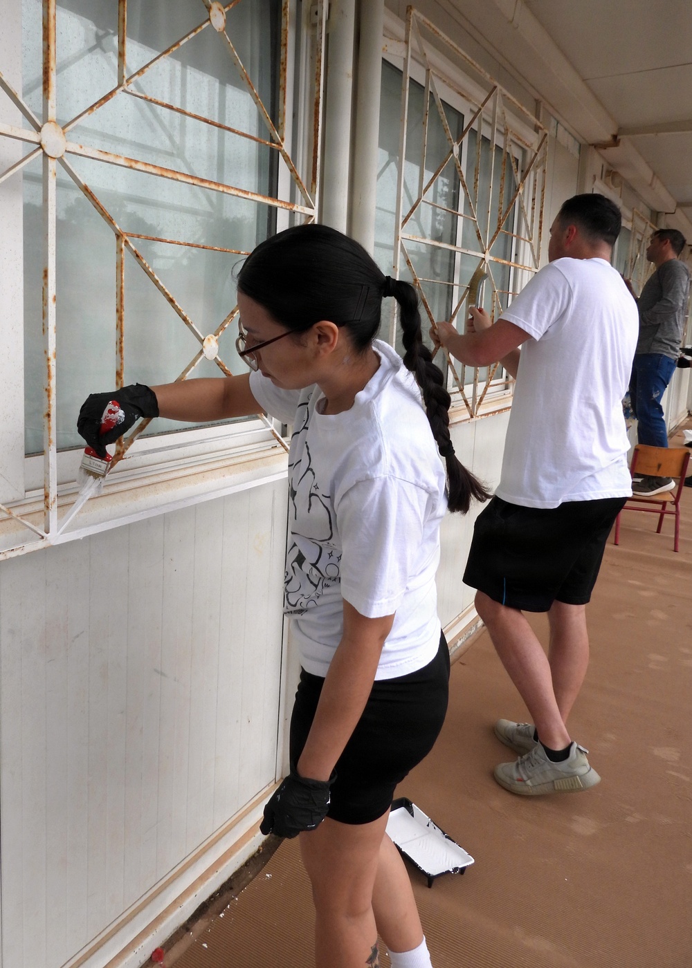 Team Souda paints a local elementary school during a community outreach event