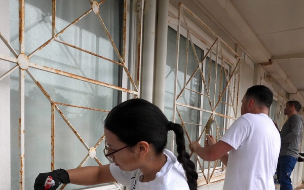 Team Souda paints a local elementary school during a community outreach event