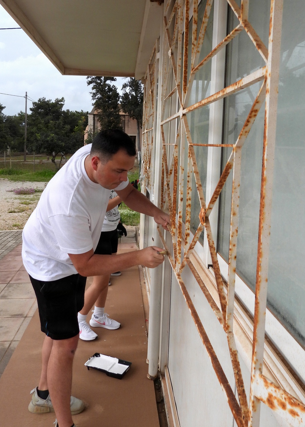 Team Souda paints a local elementary school during a community outreach event