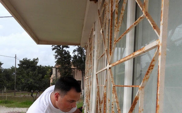 Team Souda paints a local elementary school during a community outreach event