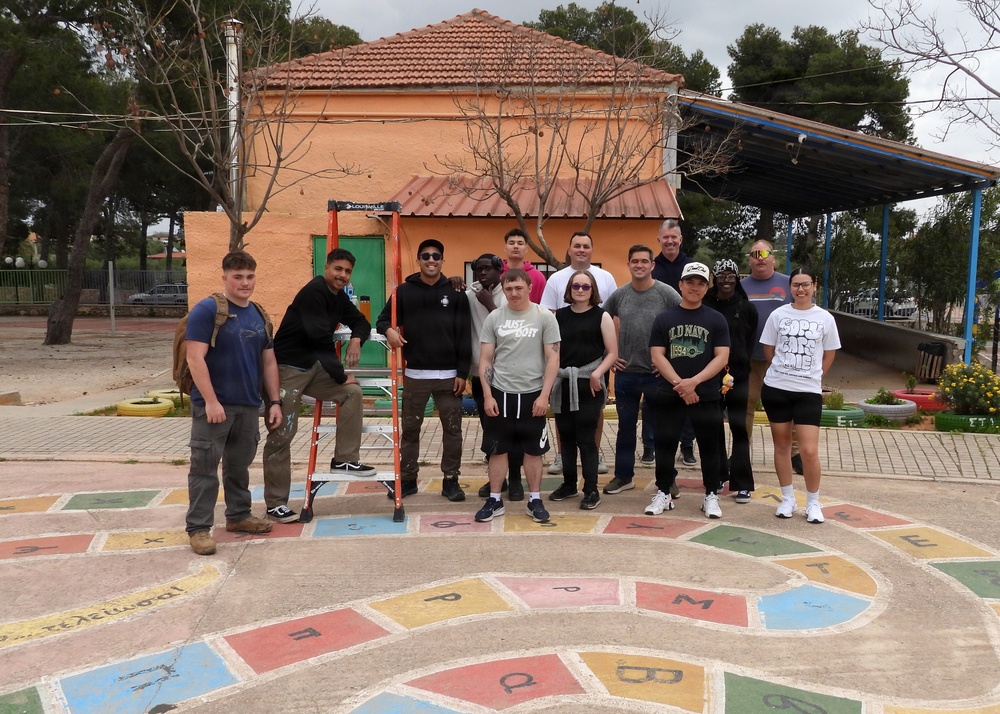 Team Souda paints a local elementary school during a community outreach