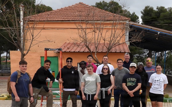 Team Souda paints a local elementary school during a community outreach