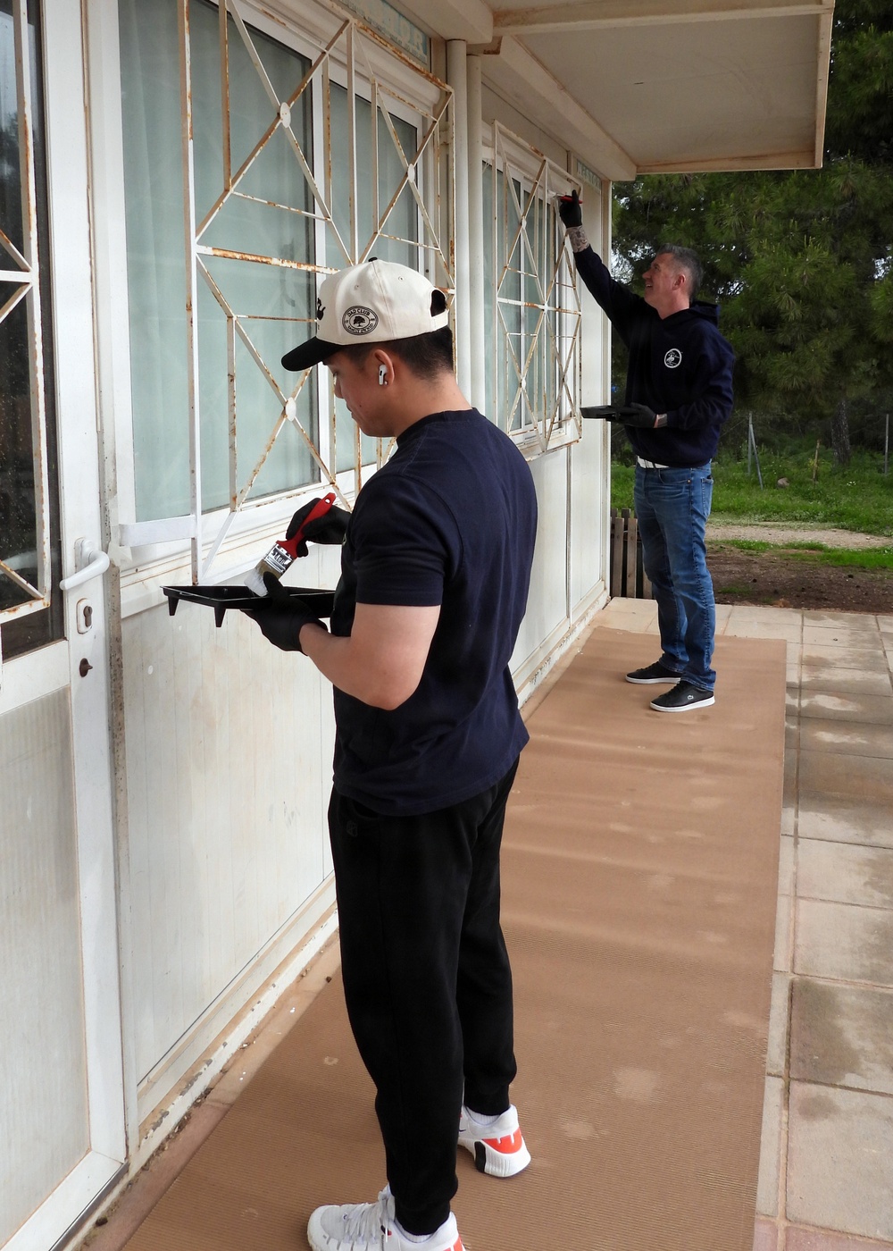 Team Souda paints a local elementary school during a community outreach event