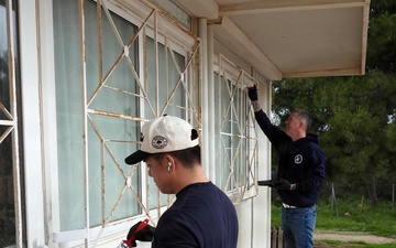 Team Souda paints a local elementary school during a community outreach event